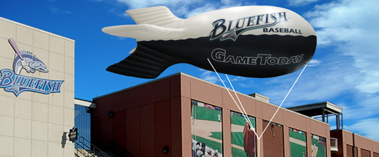 Coke a Cola and Bud Light blimps over ice rink.