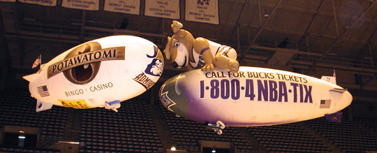 Coke a Cola and Bud Light blimps over ice rink.